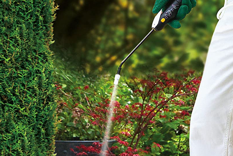 Person using a weed killer spray