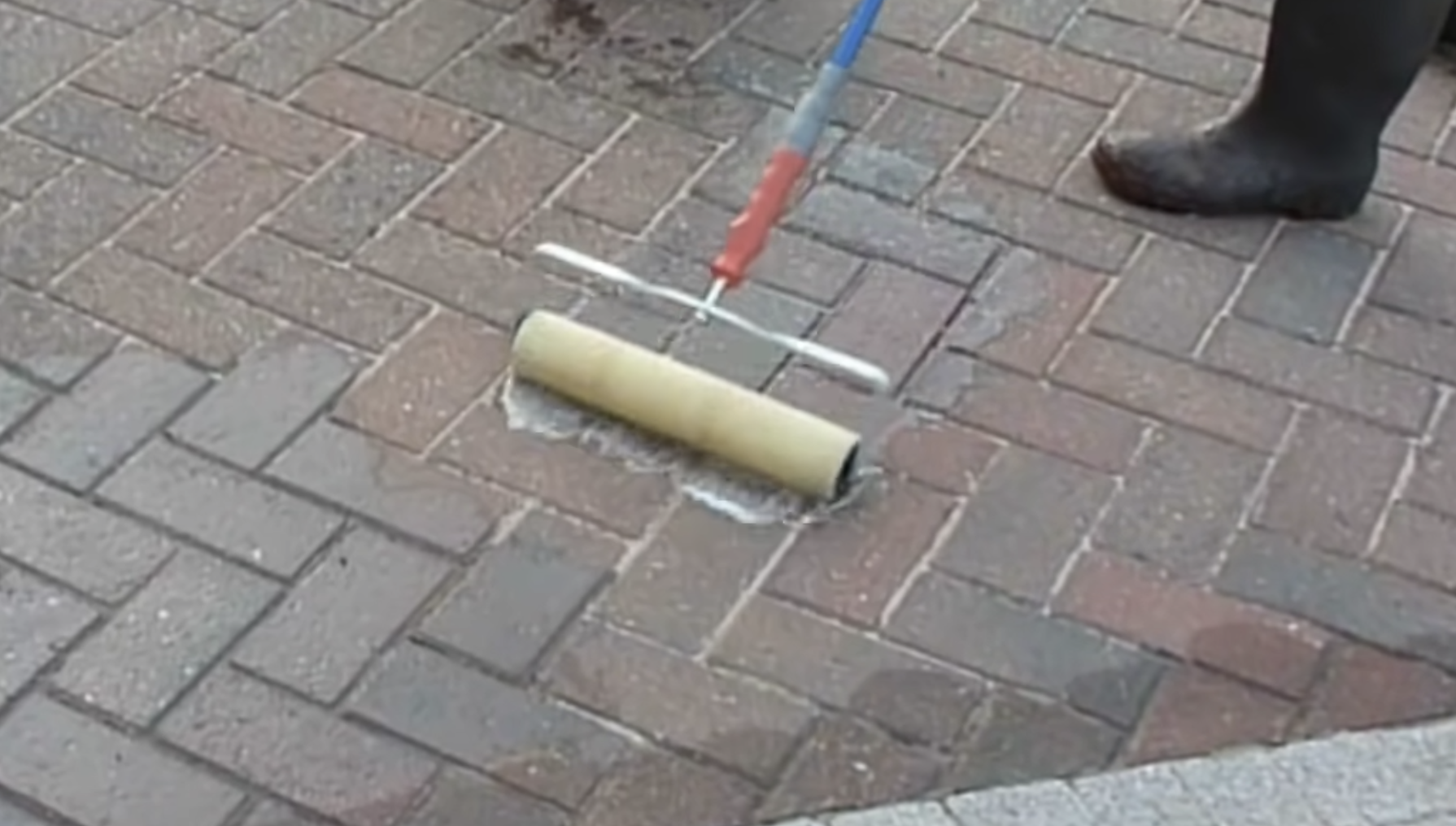 Photo of person applying block paving sealant